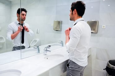 attractive-businessman-looking-at-himself-in-the-mirror_1139-256.jpg