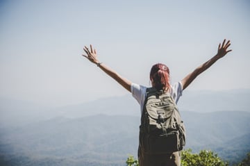 attractive-woman-hiker-open-arms-at-mountain-peak-enjoy-with-nature-travel-concept_1150-1942