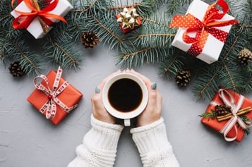 christmas-composition-with-hands-holding-coffee-and-presents_23-2147722785.jpg