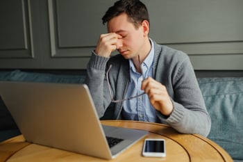 frustrated-young-man-massaging-his-nose-and-keeping-eyes-closed-while-working_8353-5961