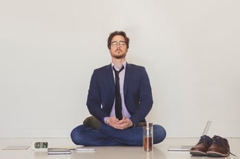 handsome-man-meditating-on-floor_23-2147791983