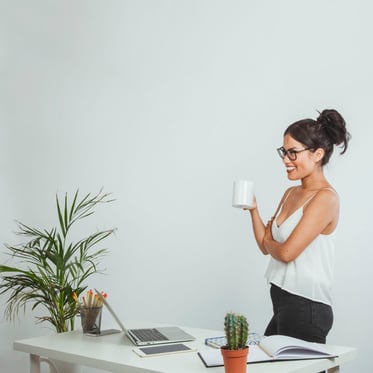 happy-businesswoman-posing-with-a-coffe-mug-in-the-office_23-2147648036.jpg