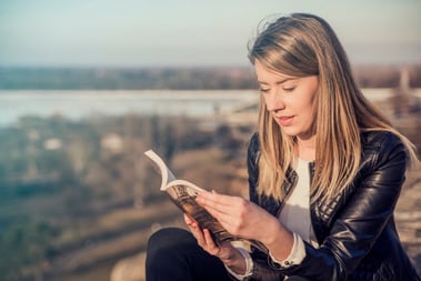 reading-her-favorite-book-beautiful-young-woman-reading-book-and-smiling-while-sitting-outdoors-landscape-on-the-background-reading-a-book-concept_1391-384.jpg