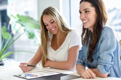 two-young-women-studying-graphics-on-white-desk_1139-981.jpg